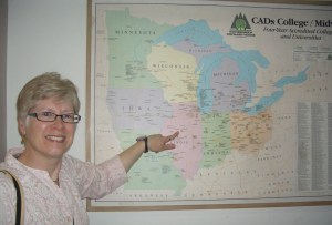 Beth pointing to IWU on the map of four year colleges in the Midwest at the Fulbright House